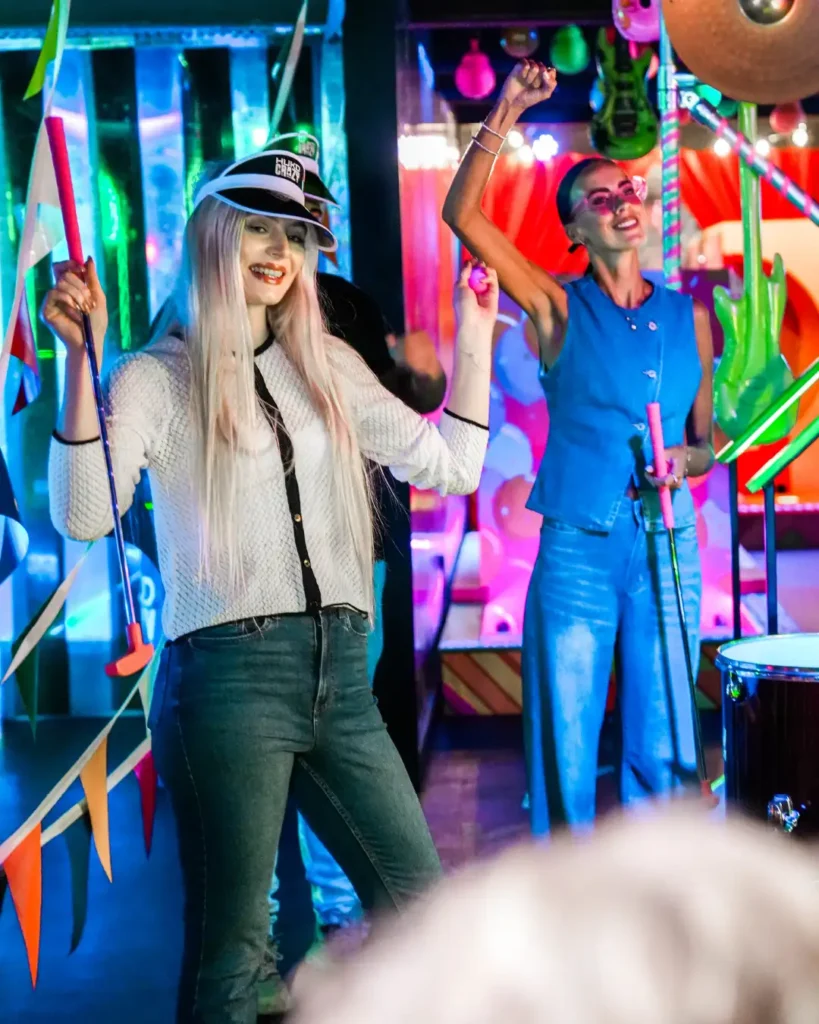 Two women playing crazy golf at Hukd