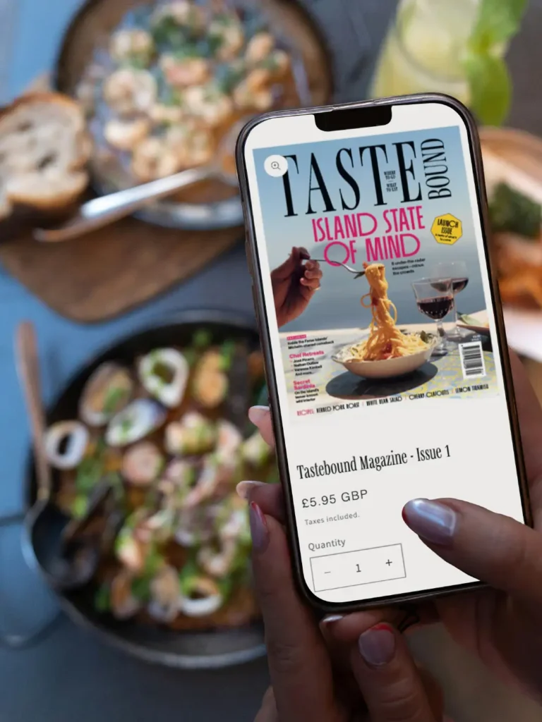 A mockup of a mobile phone displaying the tastebound magazine website