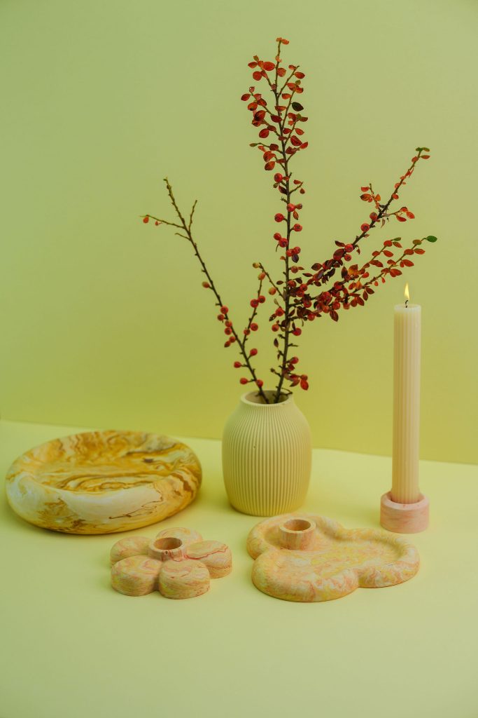 Jesmonite homewares on a green background