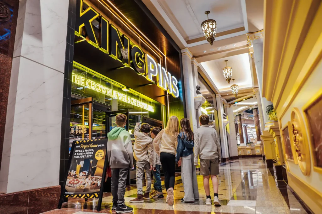 Children walking in to a king pins venue