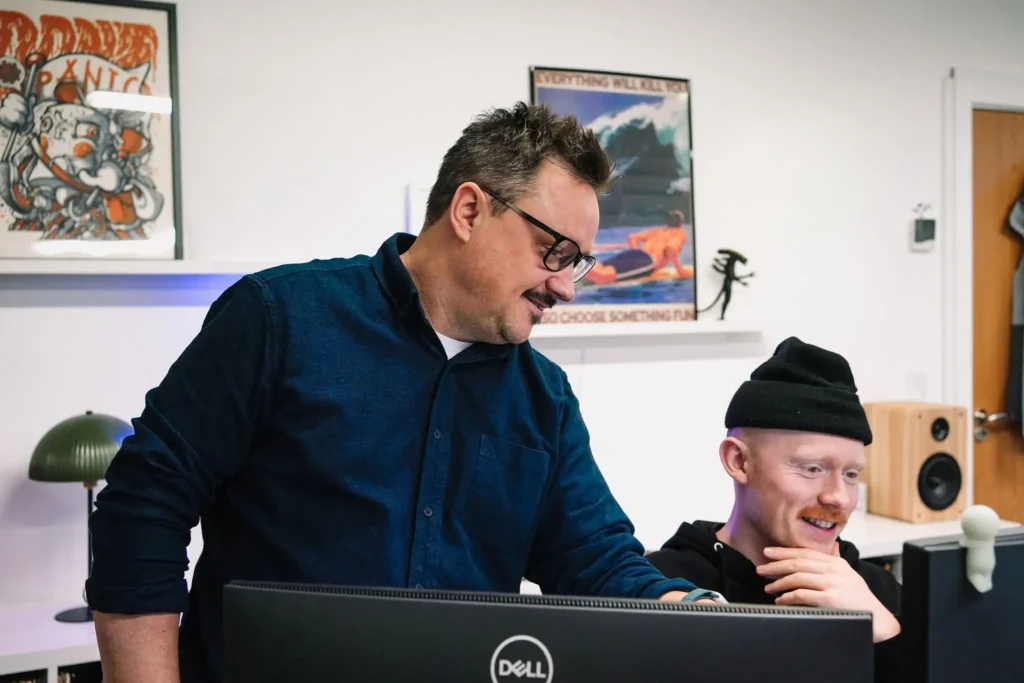 work mates chatting at their desks about design work