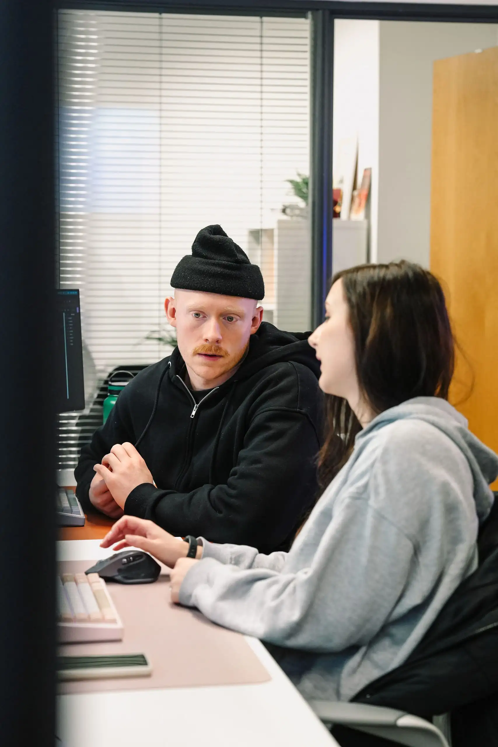 Two members of the web team at Little Green Jesus, discussing an Ecommerce Web builds SEO report