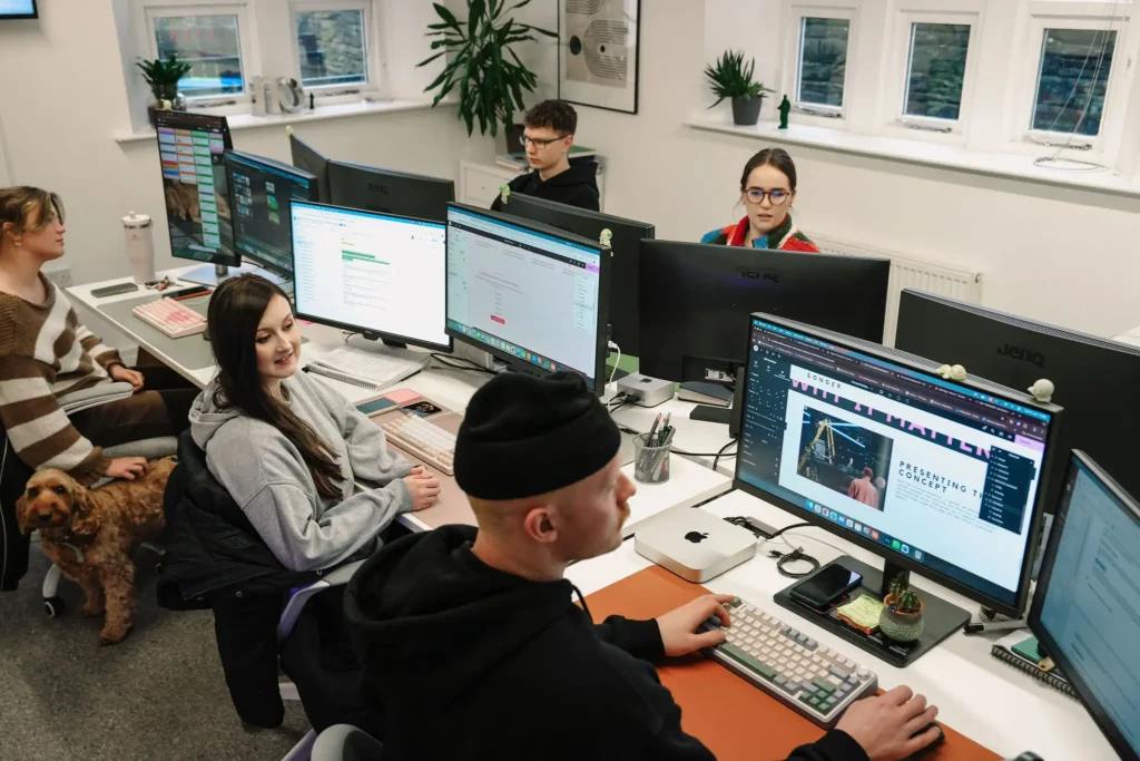 website and graphic design team in leeds studio discussing projects