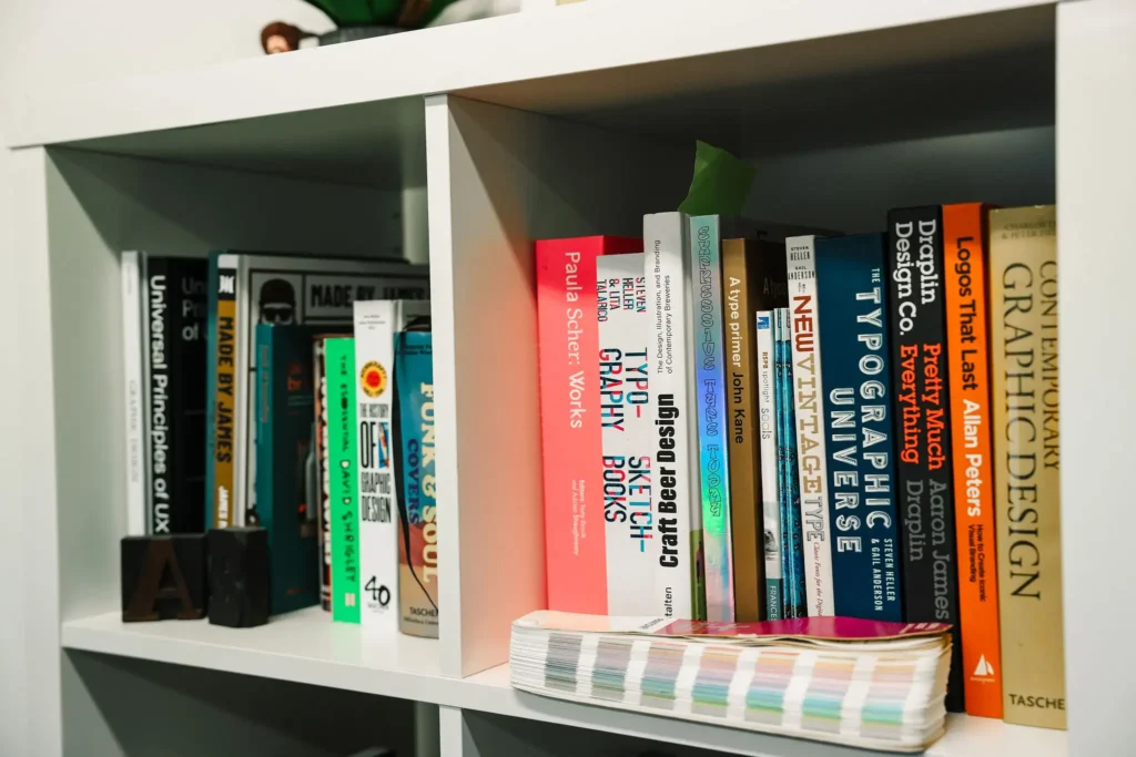 a bookcase filled with colourful books at a design agency in leeds