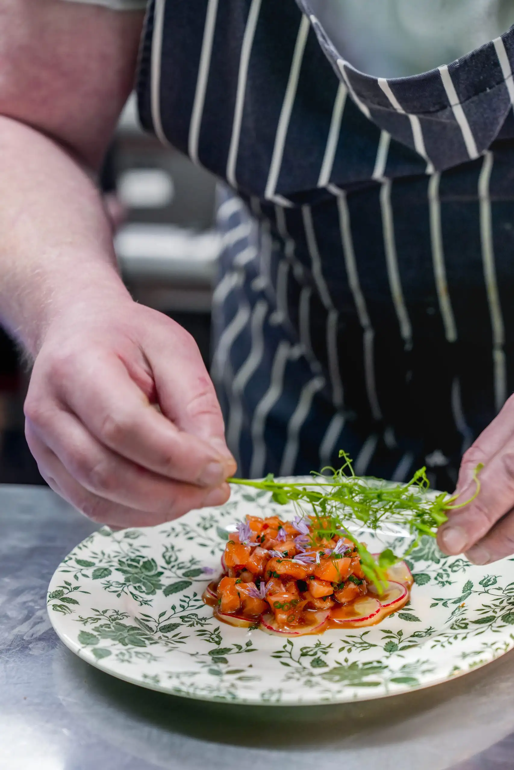 A chef making a dish as part of a commercial shoot for social media